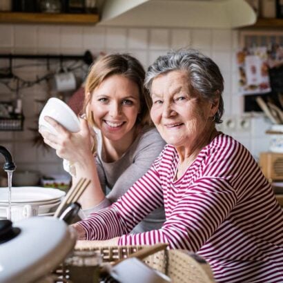 Visiting elderly home carer with care recipient